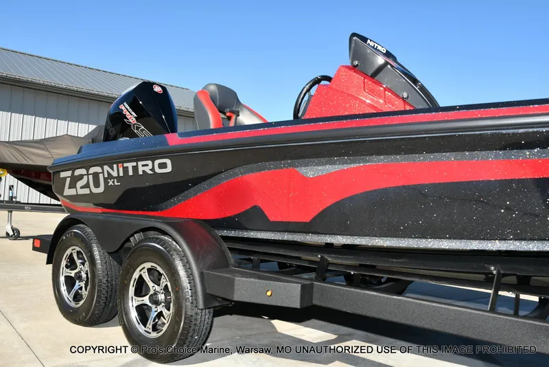 Slide: The Image of 2025 Nitro Z20 XL Pro boat with red and black design on a trailer. - 16