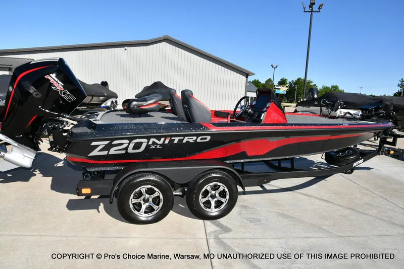 Slide: The Image of 2025 Nitro Z20 XL Pro boat with sleek design and powerful engine, parked outdoors. - 19