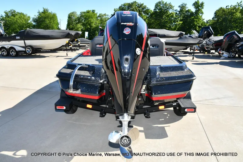 Slide: The Image of 2025 Nitro Z20 XL Pro boat, rear view, parked outdoors with other boats. - 24