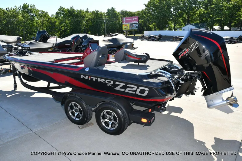Slide: The Image of 2025 Nitro Z20 XL Pro boat with sleek design and powerful engine, parked outdoors. - 25