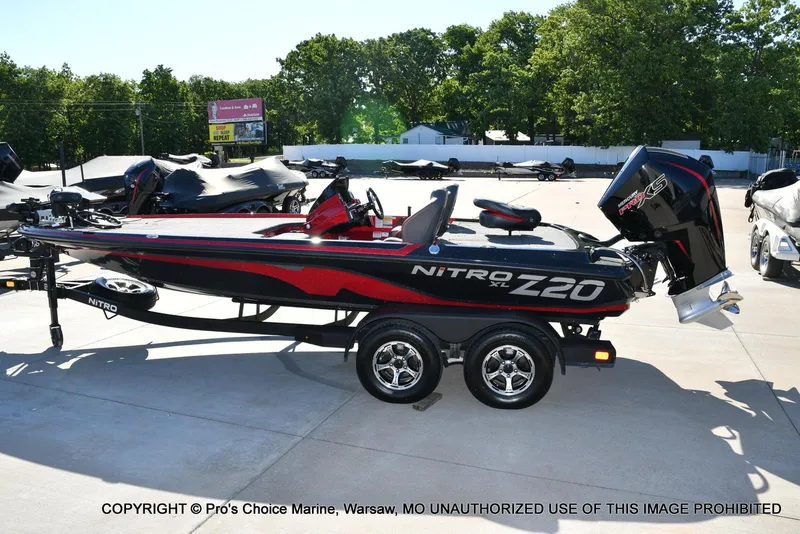 Slide: The Image of 2025 Nitro Z20 XL Pro boat on trailer, parked outdoors in a sunny setting. - 26