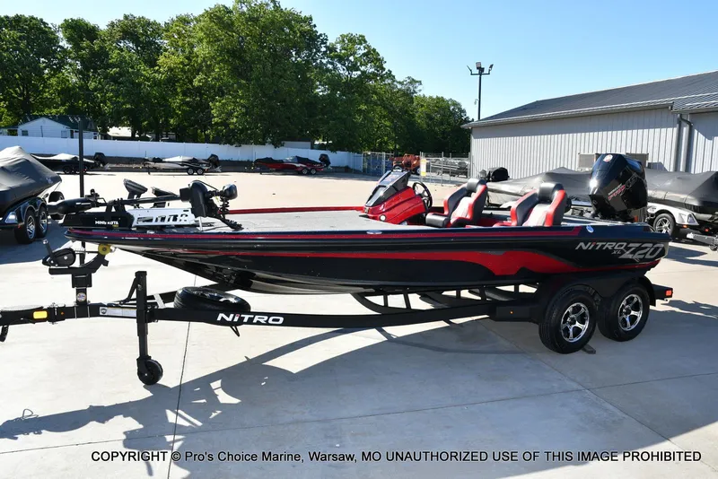 Slide: The Image of 2025 Nitro Z20 XL Pro bass boat on trailer, parked outdoors. - 27