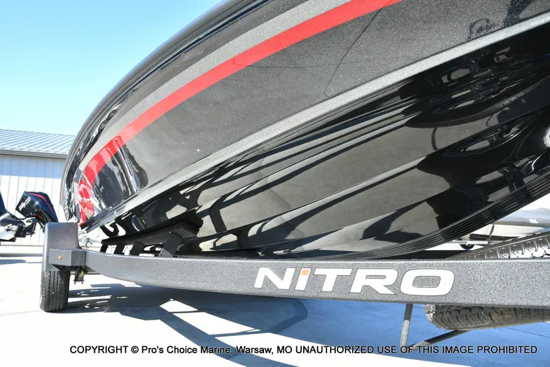 Slide: The Image of 2025 Nitro Z20 XL Pro boat on trailer, close-up view, sleek black design with red accents. - 32