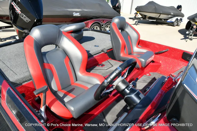 Slide: The Image of 2025 Nitro Z20 XL Pro boat interior with red and gray seats, steering wheel visible. - 36