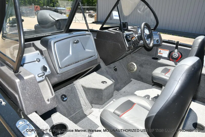 Slide: The Image of 2023 Tracker Pro Guide V-175 Combo boat interior with steering wheel and seating. - 12