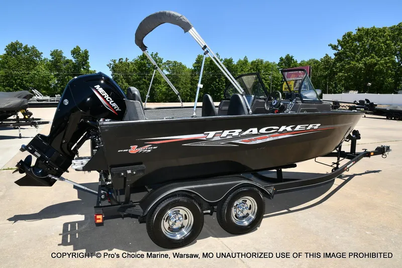Slide: The Image of 2023 Tracker Pro Guide V-175 Combo boat on trailer, outdoors, with Mercury engine. - 18