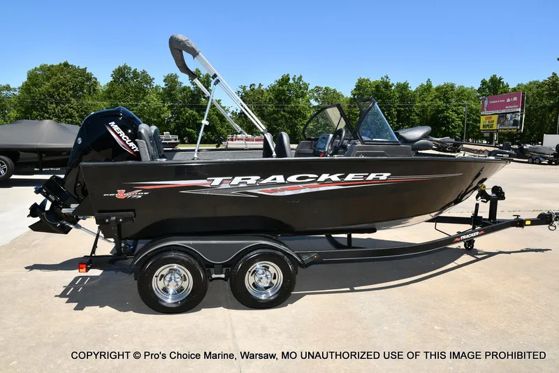 Slide: The Image of 2023 Tracker Pro Guide V-175 Combo boat on trailer, outdoors, sunny day. - 19
