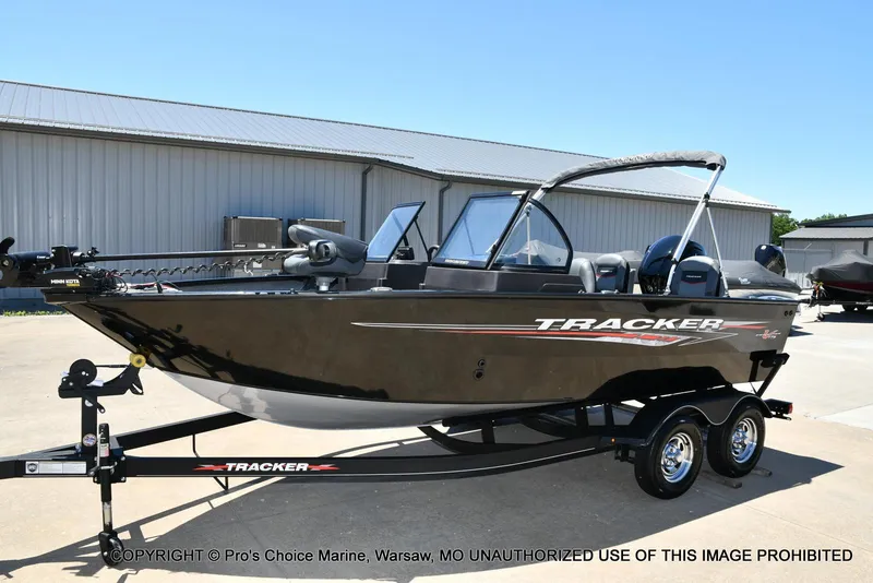 Slide: The Image of 2023 Tracker Pro Guide V-175 Combo boat on trailer, parked outdoors. - 28