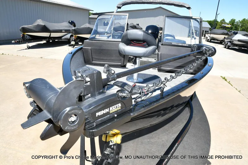 Slide: The Image of 2023 Tracker Pro Guide V-175 Combo boat with Minn Kota Terrova motor, parked outdoors. - 29