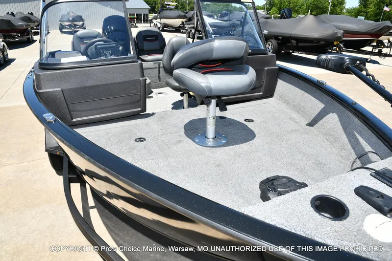 Slide: The Image of 2023 Tracker Pro Guide V-175 Combo boat with seating and fishing deck, displayed outdoors. - 33