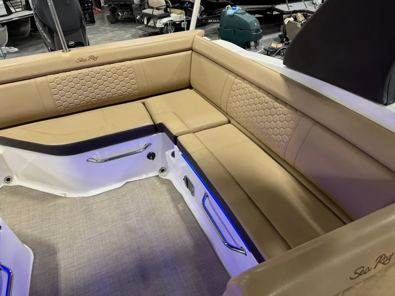 Slide: The Image of 2018 Sea Ray 270 SDX boat interior with tan leather seating and blue accent lighting. - 10