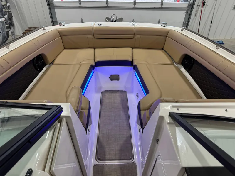 Slide: The Image of 2018 Sea Ray 270 SDX boat interior with tan seating and blue LED lighting. - 13