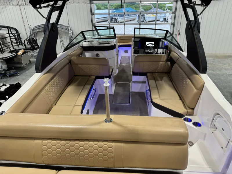 Slide: The Image of 2018 Sea Ray 270 SDX boat interior with tan seating and modern dashboard. - 7