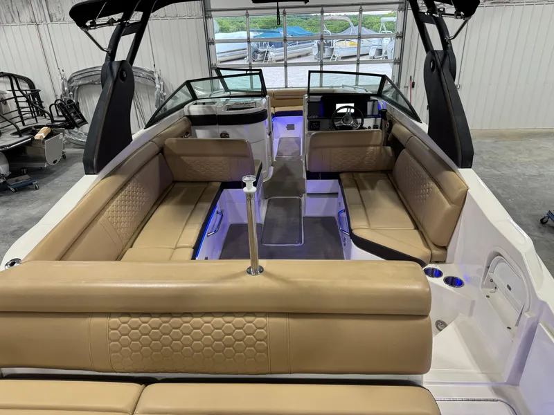 Slide: The Image of 2018 Sea Ray 270 SDX boat interior with tan seating and modern dashboard. - 9