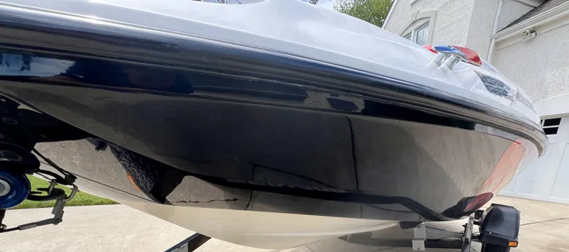 Slide: The Image of 2011 Sea-Doo 150 Speedster boat on trailer, close-up view of hull. - 11