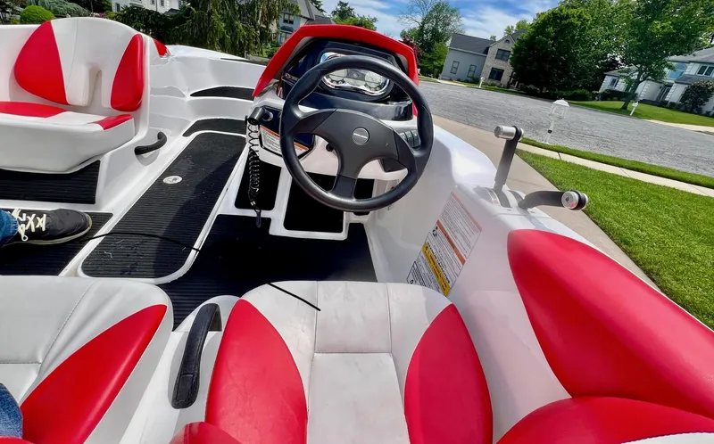 Slide: The Image of 2011 Sea-Doo 150 Speedster interior with red and white seating, steering wheel, and dashboard. - 3