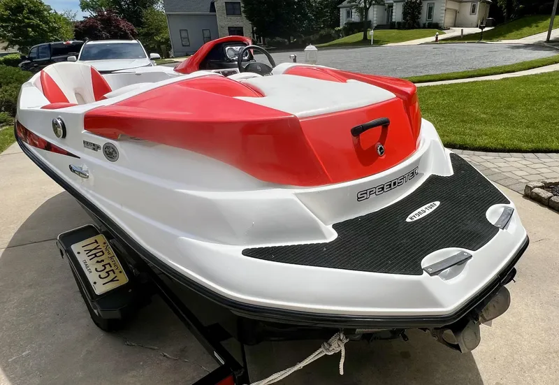 Slide: The Image of 2011 Sea-Doo 150 Speedster boat with red and white design on a trailer. - 4