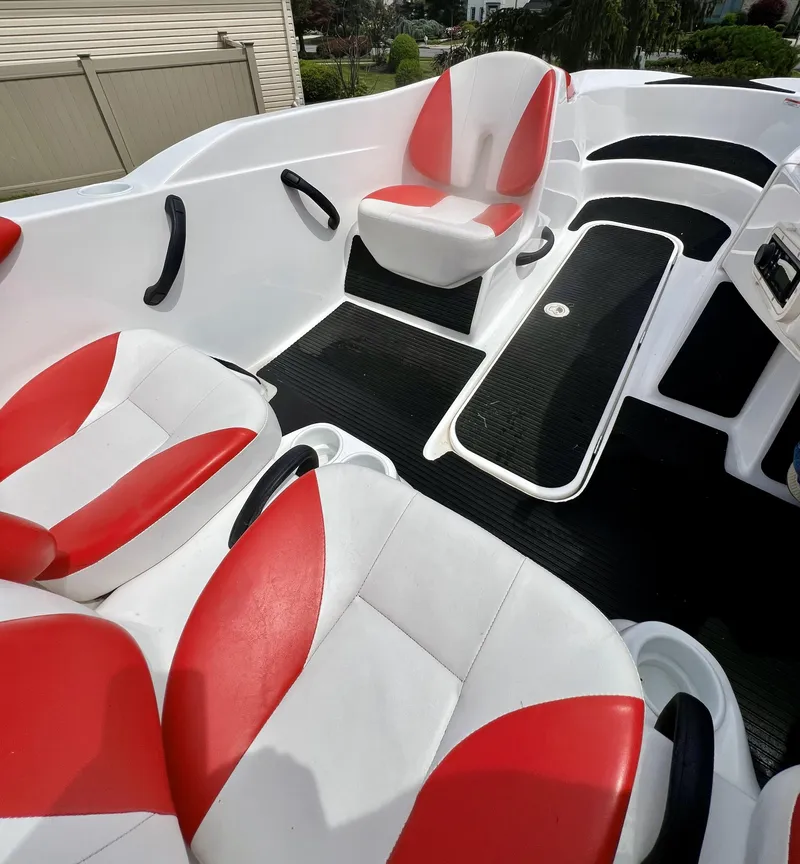 Slide: The Image of 2011 Sea-Doo 150 Speedster interior with red and white seating, black flooring. - 5