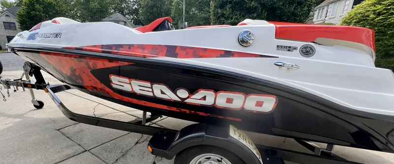 Slide: The Image of 2011 Sea-Doo 150 Speedster boat on trailer, featuring bold red and black design. - 6