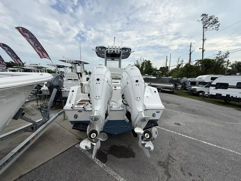 Slide: The Image of 2025 Tidewater 272 LXF boat with dual outboard engines, displayed outdoors. - 14