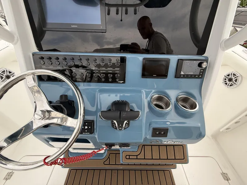 Slide: The Image of 2025 Tidewater 272 LXF boat dashboard with steering wheel, controls, and electronic displays. - 11