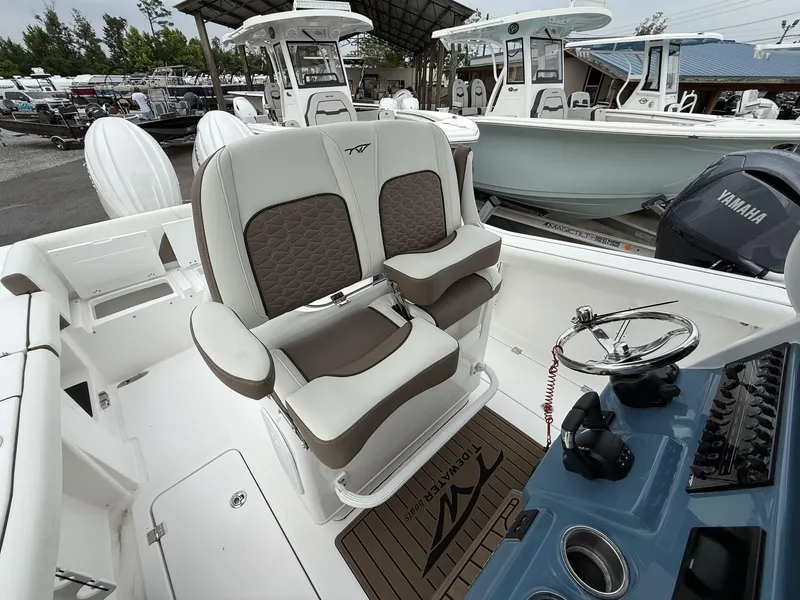 Slide: The Image of 2025 Tidewater 272 LXF boat interior with dual seats and steering console. - 13