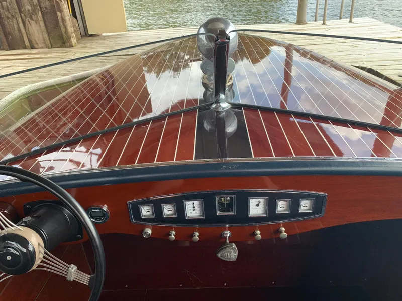 Slide: The Image of 1981 Hugh Saint Shearliner 27 boat dashboard with classic wooden finish and vintage controls. - 4