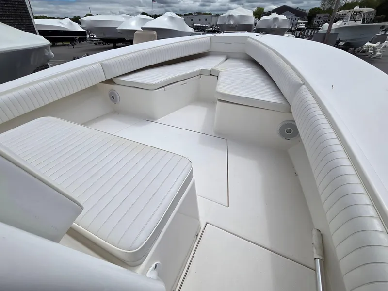 Slide: The Image of 2005 Regulator 32 Forward Seating boat with spacious white interior and cushioned seats. - 16