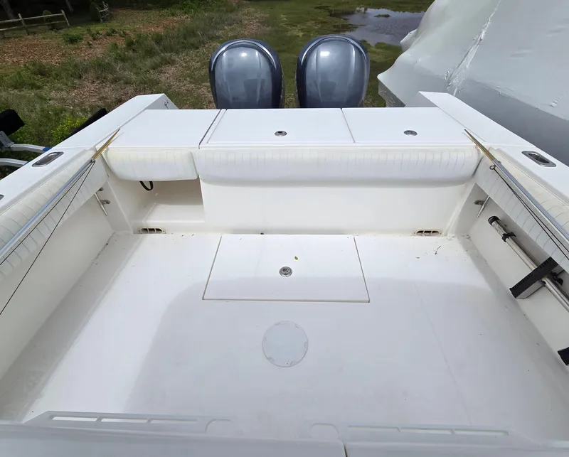 Slide: The Image of 2005 Regulator 32 Forward Seating boat deck with twin engines, spacious and clean layout. - 17