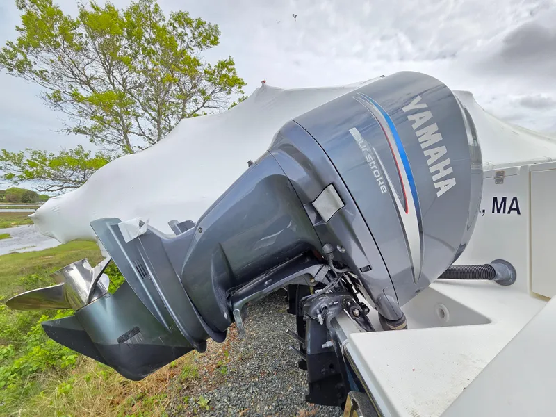 Slide: The Image of 2005 Regulator 32 Forward Seating boat with Yamaha outboard motor, parked outdoors. - 5