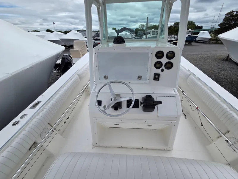 Slide: The Image of 2005 Regulator 32 Forward Seating boat with white console and steering wheel. - 7