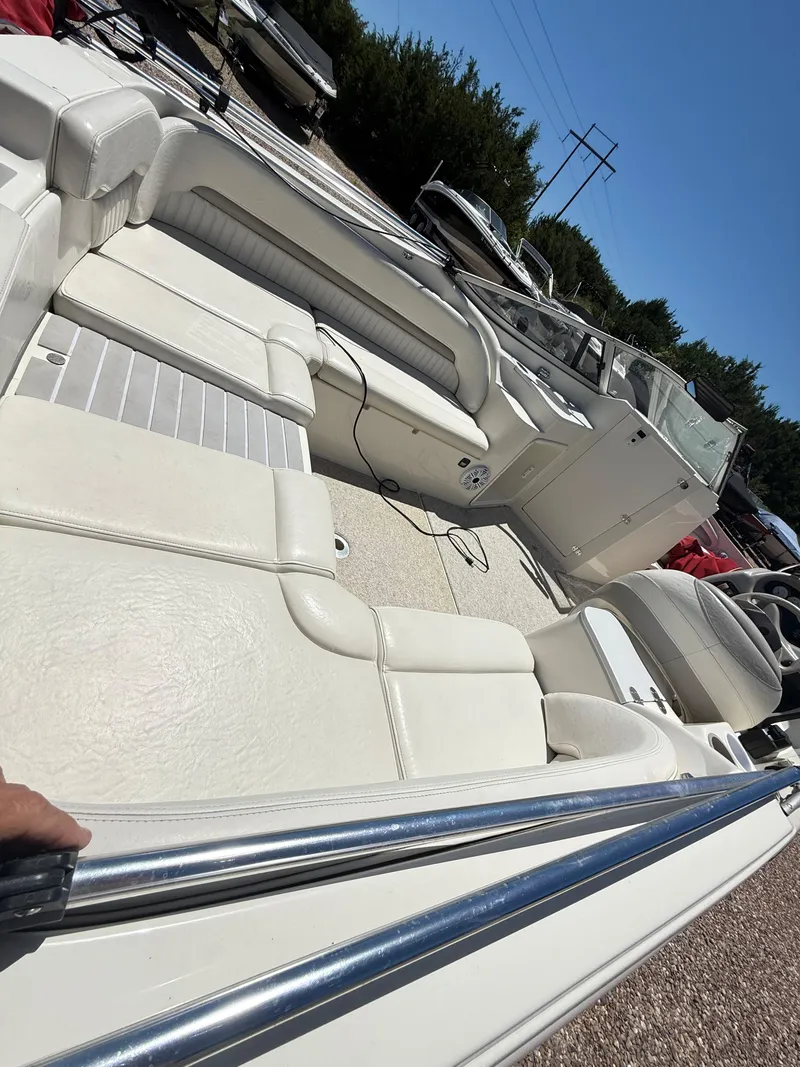 Slide: The Image of 2005 Stingray 220 DR boat interior with white seating and steering console. - 10