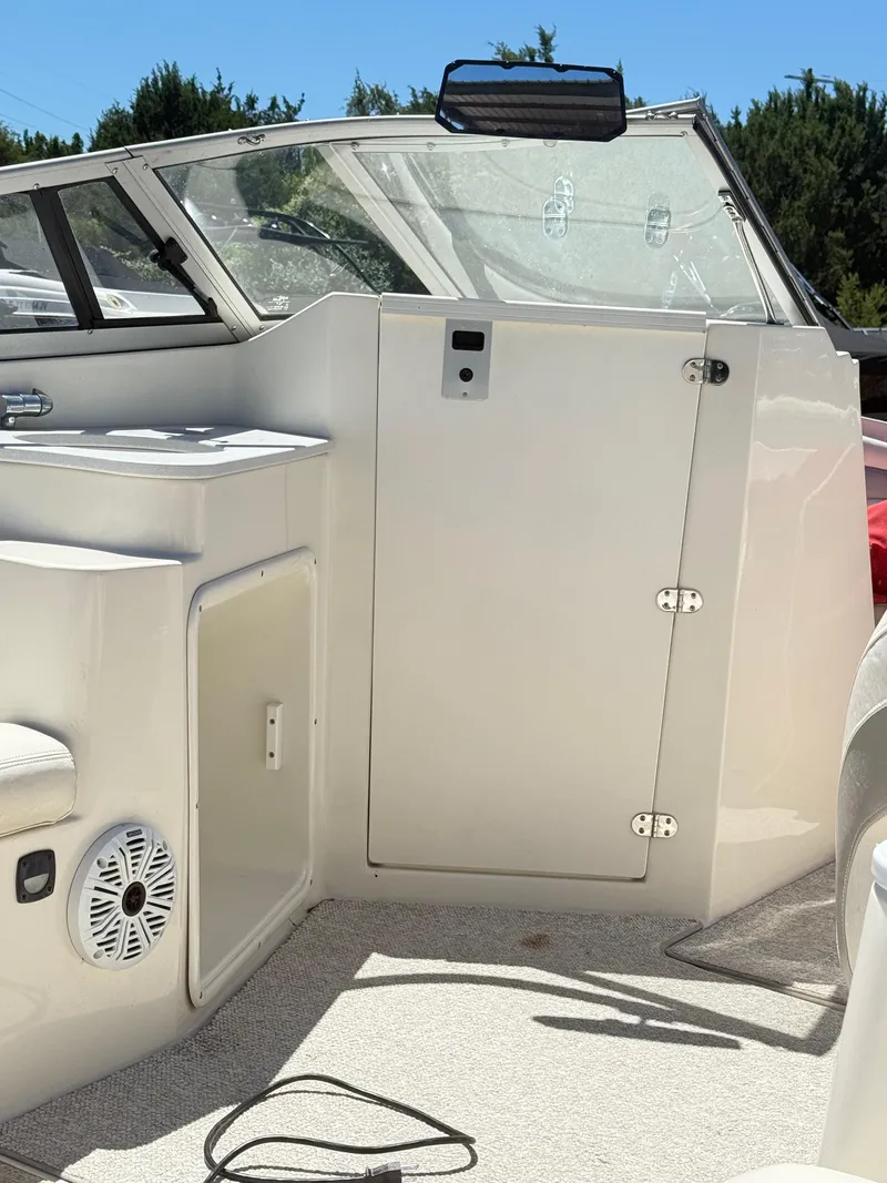 Slide: The Image of 2005 Stingray 220 DR boat interior with seating, storage, and speaker. - 12