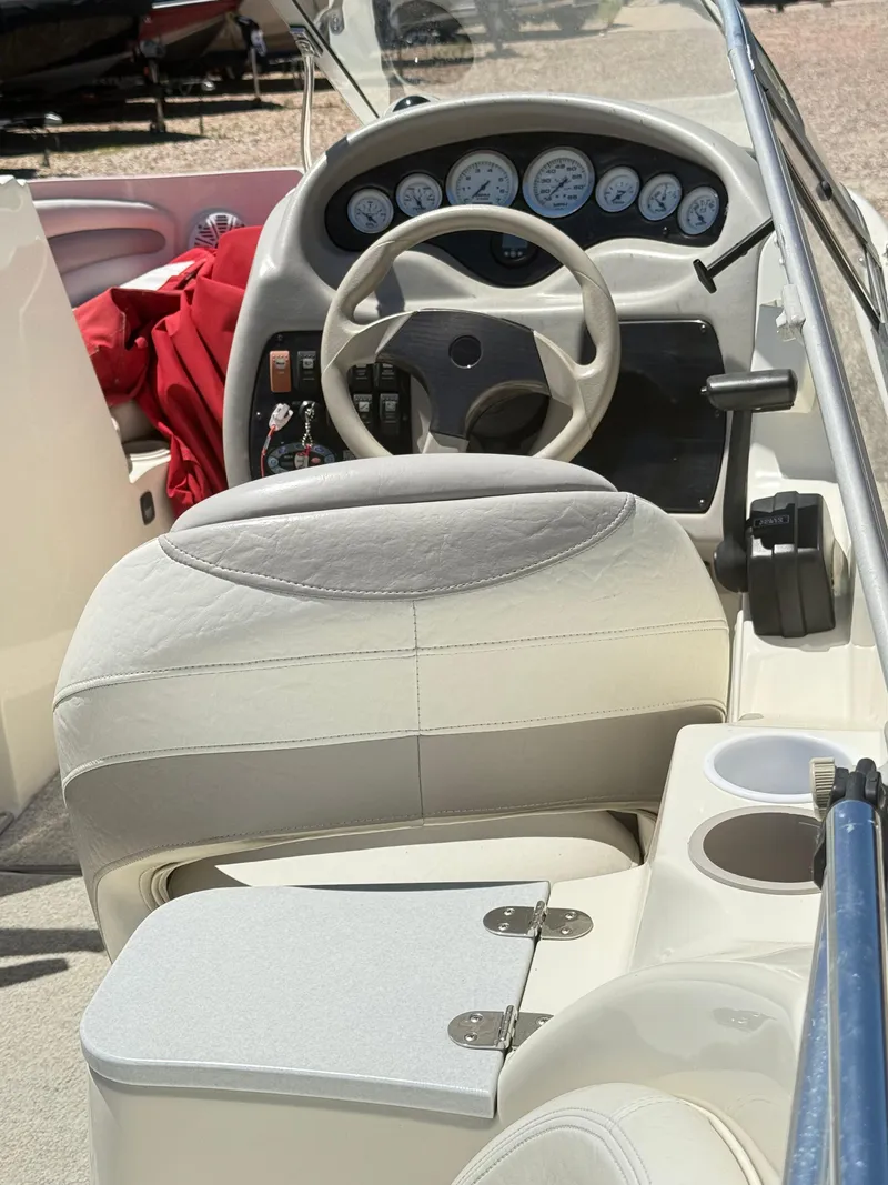 Slide: The Image of 2005 Stingray 220 DR boat cockpit with steering wheel and instrument panel. - 13