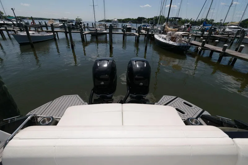 Slide: The Image of 2020 Cruisers Yachts 338 SS OB at marina with twin outboard engines. - 12
