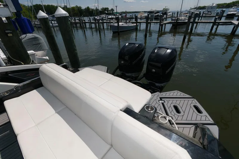 Slide: The Image of 2020 Cruisers Yachts 338 SS OB at dock with dual outboard engines. - 13