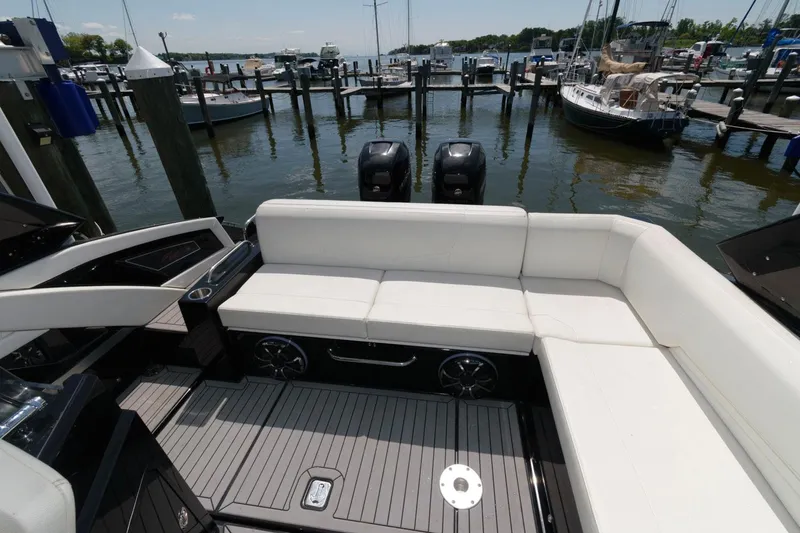 Slide: The Image of 2020 Cruisers Yachts 338 SS OB with white seating, docked at marina. - 14