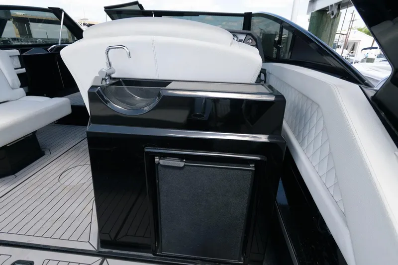 Slide: The Image of 2020 Cruisers Yachts 338 SS OB interior with sink and seating area. - 15