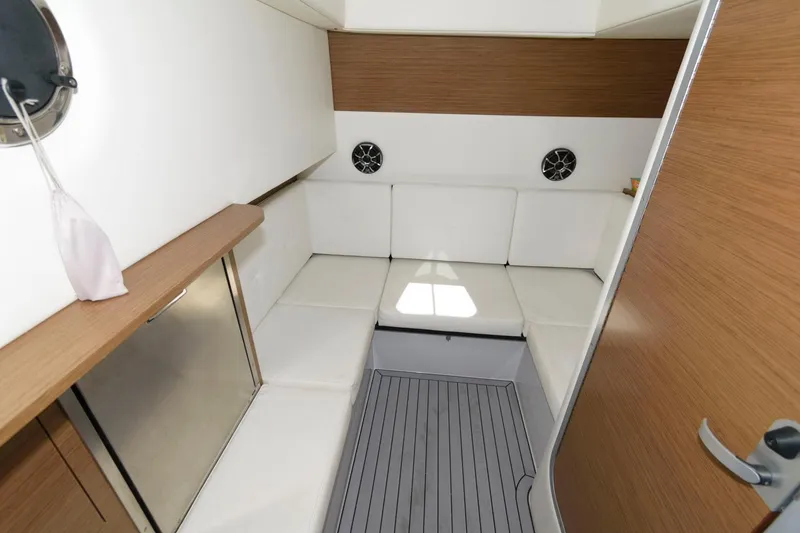 Slide: The Image of Interior cabin of 2020 Cruisers Yachts 338 SS OB with white seating and wood accents. - 16