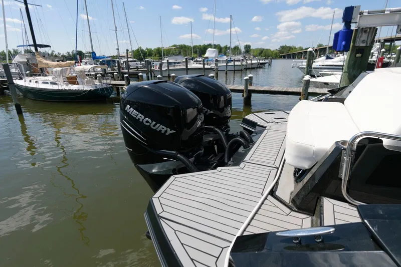 Slide: The Image of 2020 Cruisers Yachts 338 SS OB with Mercury outboards docked at a marina. - 18
