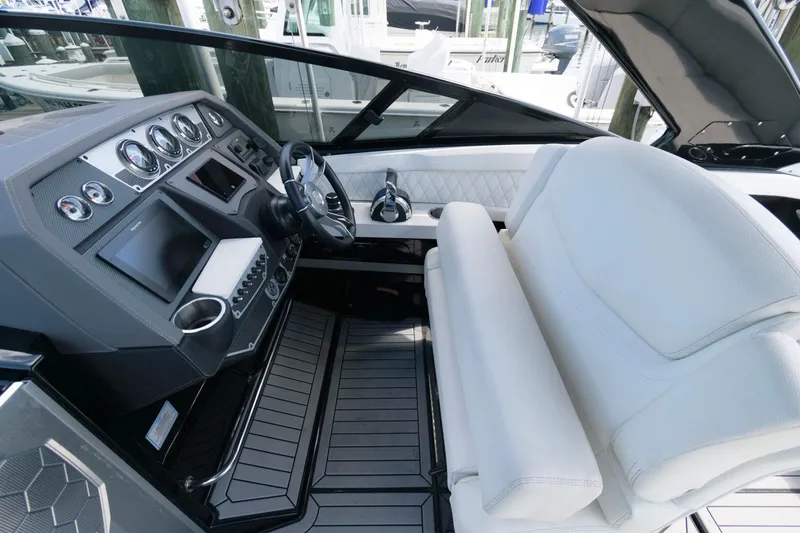 Slide: The Image of 2020 Cruisers Yachts 338 SS OB cockpit with modern dashboard and white seating. - 5