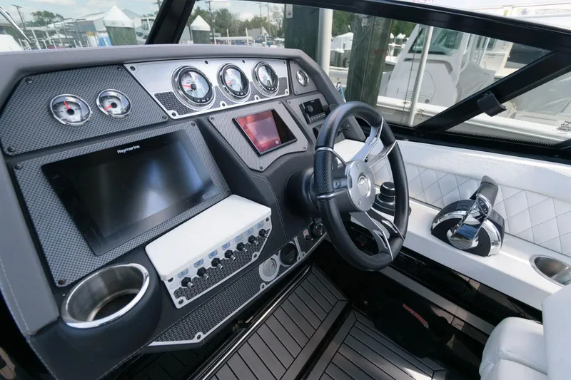 Slide: The Image of 2020 Cruisers Yachts 338 SS OB dashboard with modern controls and steering wheel. - 6
