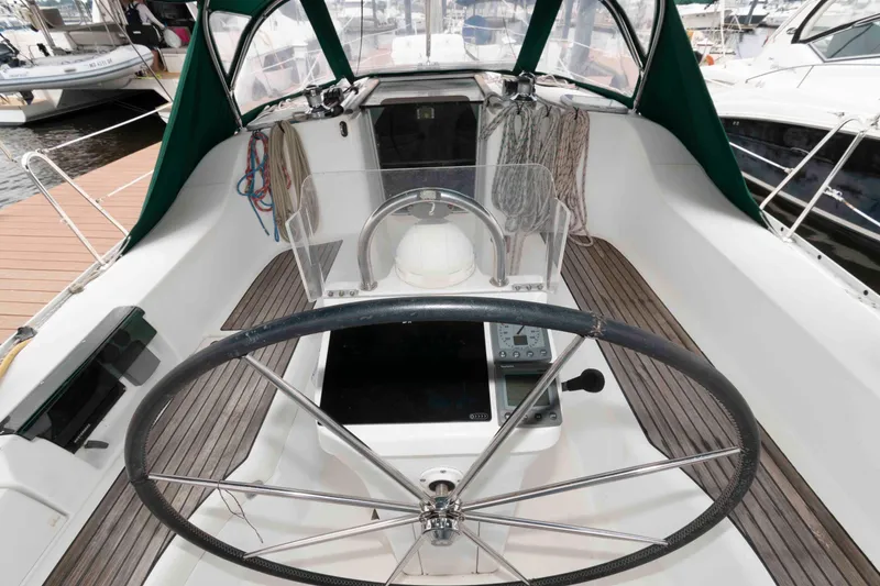Slide: The Image of Cockpit of 2003 Beneteau 393 sailboat with steering wheel and navigation equipment. - 10