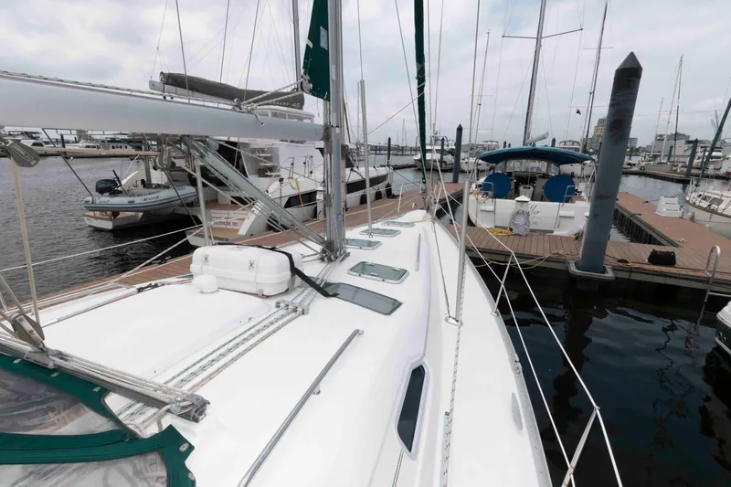 Slide: The Image of 2003 Beneteau 393 sailboat docked at marina, showcasing deck and rigging. - 12