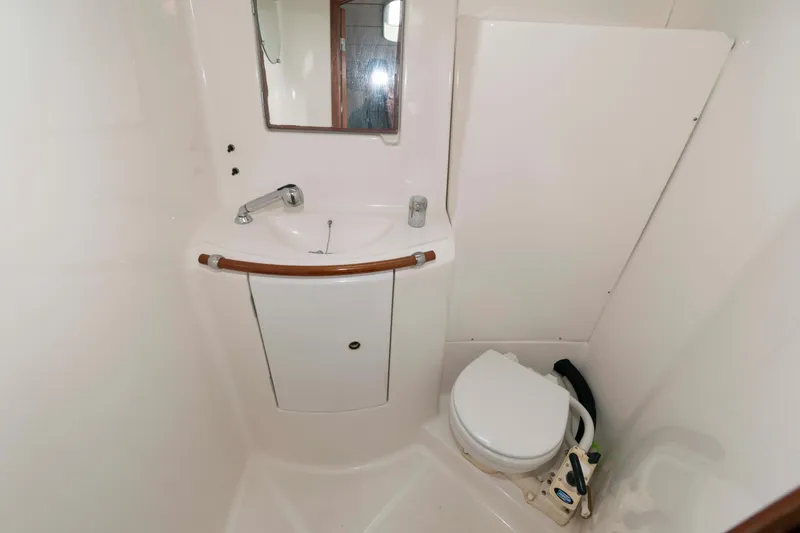 Slide: The Image of Compact bathroom in a 2003 Beneteau 393 sailboat, featuring a sink and toilet. - 20