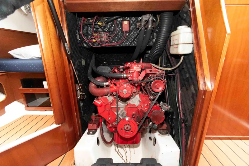 Slide: The Image of Engine compartment of a 2003 Beneteau 393 sailboat, featuring a red marine engine. - 23
