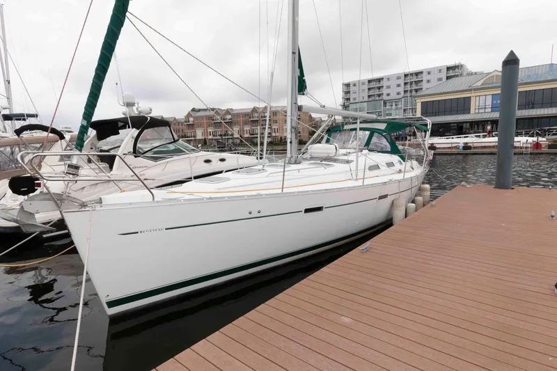 Slide: The Image of 2003 Beneteau 393 sailboat docked at marina, surrounded by other boats. - 4