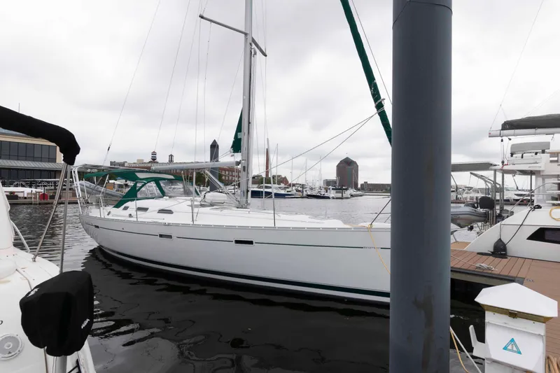 Slide: The Image of 2003 Beneteau 393 sailboat docked in a marina, overcast sky. - 5