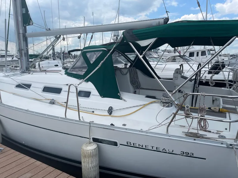 Slide: The Image of 2003 Beneteau 393 sailboat docked at marina under cloudy sky. - 6