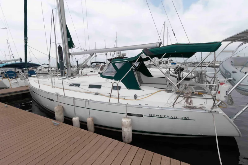 Slide: The Image of 2003 Beneteau 393 sailboat docked at marina with green canopy. - 8